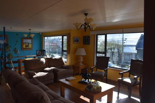 a living room with a couch and a table at Asói Hostal in Puerto Natales