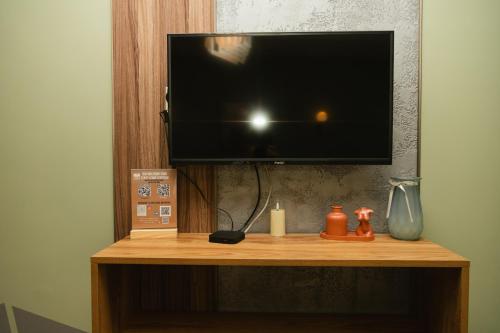 a flat screen tv sitting on top of a wooden shelf at Hotel Graif Ti in Tbilisi City