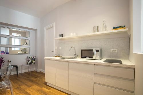 a kitchen with a sink and a microwave at Piano Nobile Rooms in Split
