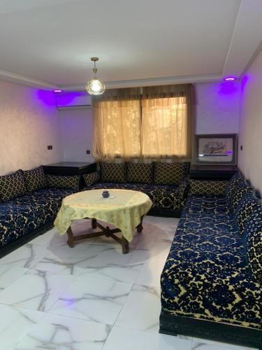 a living room with couches and a table in a room at Dar Salam in Agadir