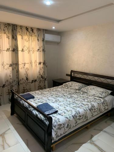 a bedroom with a bed in a room with curtains at Dar Salam in Agadir