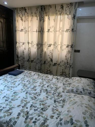 a bed in a bedroom with curtains and a bed sidx sidx sidx at Dar Salam in Agadir