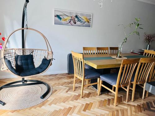 a dining room with a swing chair and a table at Casa hermosa piscina con parrilla in Victoria