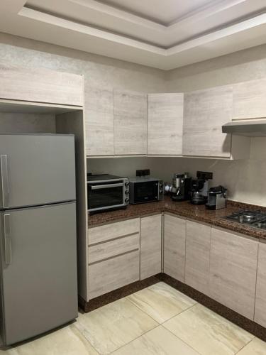 a kitchen with a refrigerator and a microwave at Dar Salam in Agadir