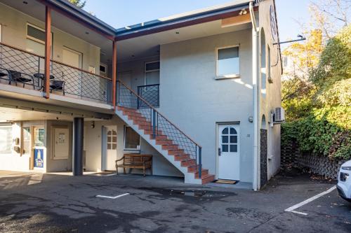 a building with a staircase on the side of it at Elphin Serviced Apartments in Launceston