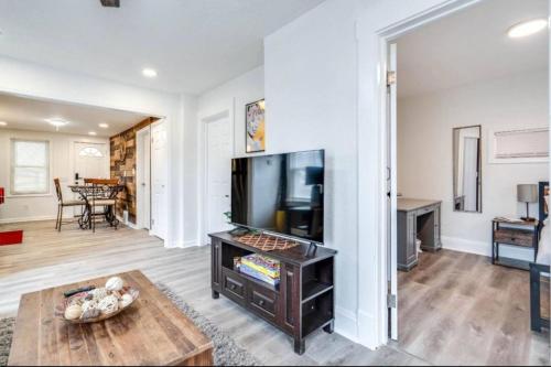 a living room with a television and a table at Pearl House in Cleveland