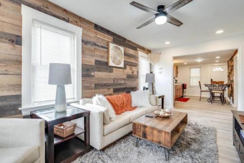 a living room with a white couch and a wooden wall at Pearl House in Cleveland