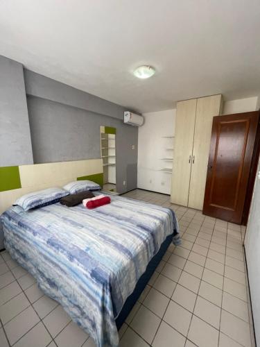 a bedroom with a bed with a red suitcase on it at Flat Mont Blanc - Perto de Tudo! in São Luís