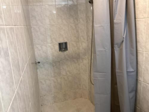 a shower with a glass door in a bathroom at Habitación privada zona Satélite in Mexico City