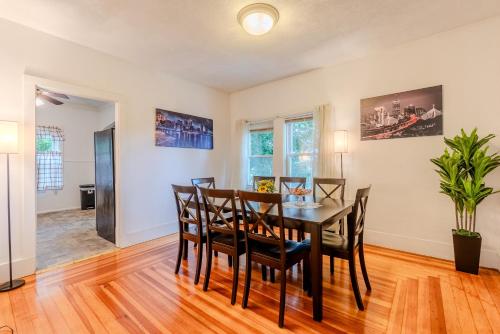 a dining room with a table and chairs at Cozy 4BDR, Tufts, Train, Parking, 10 min to Boston in Medford