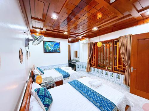 a room with three beds on a boat at The Hill Villas in Phong Nha