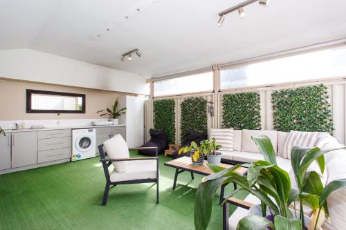 a living room with a couch and a table at Sunset Serenity in Scarborough in Perth