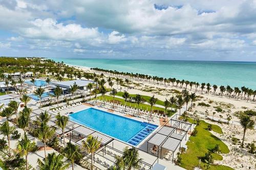 an aerial view of a resort with a pool and the beach at Riu in Cancún