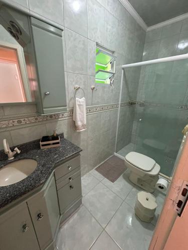 a bathroom with a shower and a toilet and a sink at Residência Vó Nilton in Governador Celso Ramos