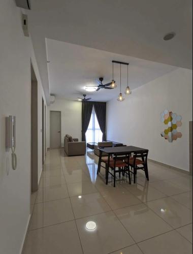 a dining room with a black table and chairs at Kiddo Best Home in Puchong