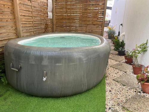 a large tub sitting on the grass in a yard at Le Calypso - Residence Terre et Truffes in Le Lamentin