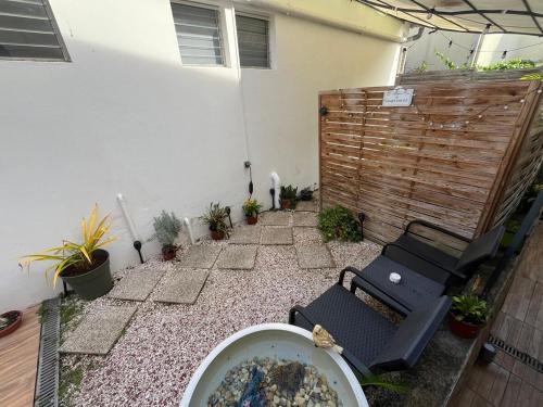 a backyard with a hot tub and a fence at Le Calypso - Residence Terre et Truffes in Le Lamentin