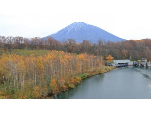 a mountain in the distance with a river and trees at Skye Niseko - Vacation STAY 30738v in Niseko