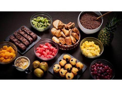 a table topped with bowls of different types of food at Skye Niseko - Vacation STAY 30752v in Niseko