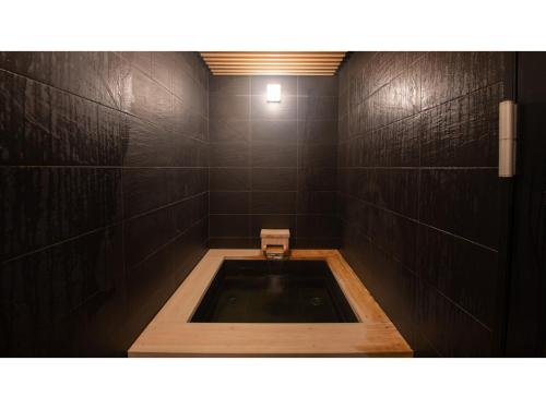 a bathroom with a bath tub with a sink at Skye Niseko - Vacation STAY 30764v in Niseko