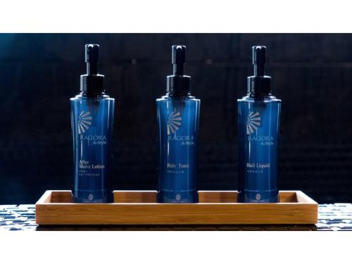 a couple of blue bottles on a wooden shelf at Skye Niseko - Vacation STAY 30764v in Niseko