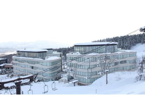 a building with a ski lift in the snow at Skye Niseko - Vacation STAY 30771v in Niseko