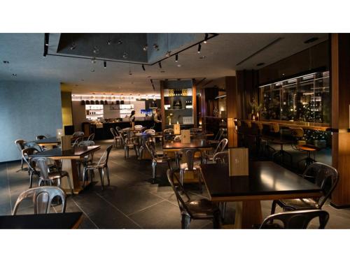 a dining room with tables and chairs in a restaurant at Skye Niseko - Vacation STAY 41529v in Niseko