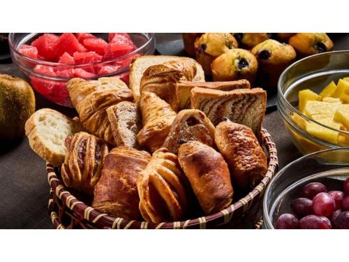 a basket filled with different types of bread and fruit at Skye Niseko - Vacation STAY 41529v in Niseko