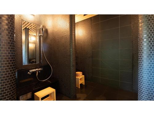 a bathroom with a shower and a sink and a mirror at Skye Niseko - Vacation STAY 41541v in Niseko