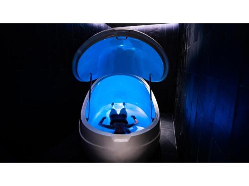 a toilet with a blue tank in a dark room at Skye Niseko - Vacation STAY 41541v in Niseko