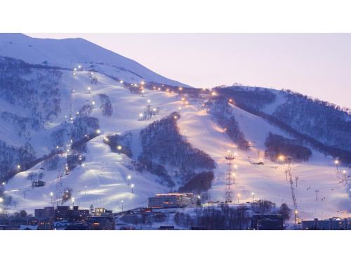 a snow covered mountain with lights on a ski slope at Skye Niseko - Vacation STAY 41541v in Niseko