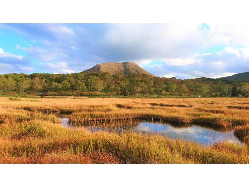 a mountain in the middle of a field with water at Skye Niseko - Vacation STAY 41541v in Niseko