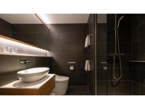 a bathroom with a sink and a toilet and a shower at Skye Niseko - Vacation STAY 41547v in Niseko