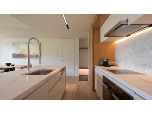 a kitchen with two sinks and a counter top at Skye Niseko - Vacation STAY 41526v in Niseko