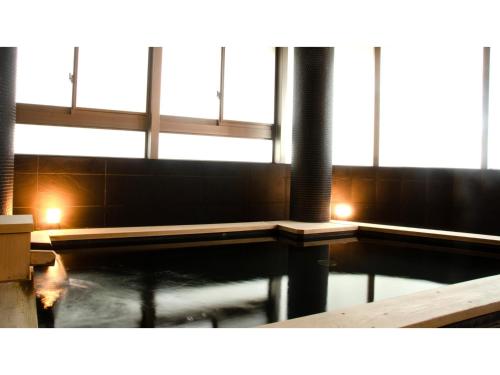 a pool of water in a building with windows at Skye Niseko - Vacation STAY 70567v in Niseko