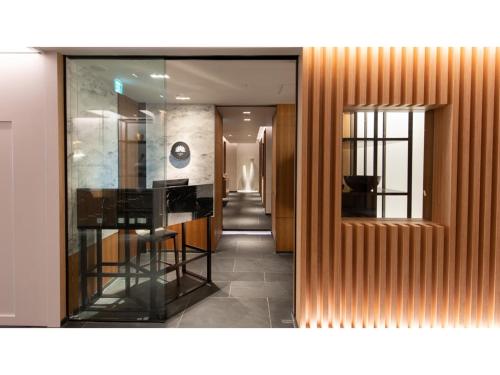 a hallway with wooden walls and a glass window at Skye Niseko - Vacation STAY 70567v in Niseko