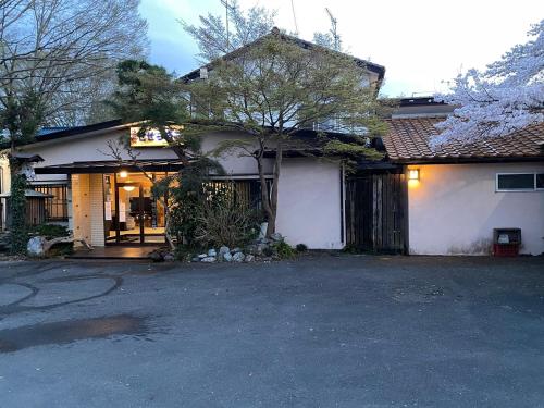 a house with a driveway in front of it at 料理自慢の温泉宿せせらぎ荘 in Chichibu