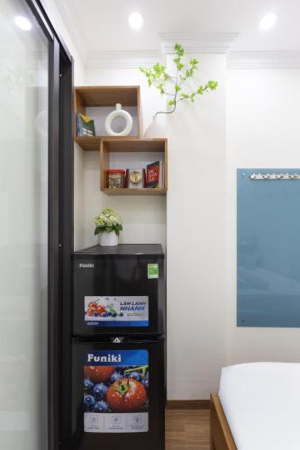 a black refrigerator in a room with shelves at Sunny Street Hotel in Hanoi