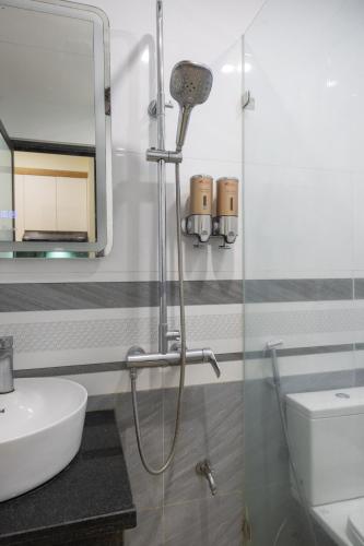 a bathroom with a shower and a sink at Sunny Street Hotel in Hanoi