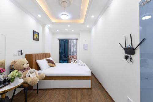 a small bedroom with a bed and a teddy bear at Sunny Street Hotel in Hanoi