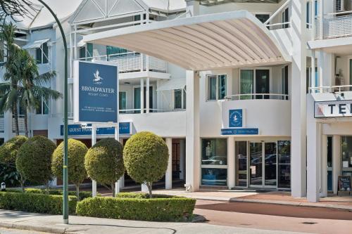 a building with a sign in front of it at Broadwater Resort Como in Perth