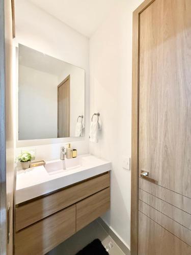 a bathroom with a white sink and a mirror at Baia Krystal P4, 1A in Cartagena de Indias