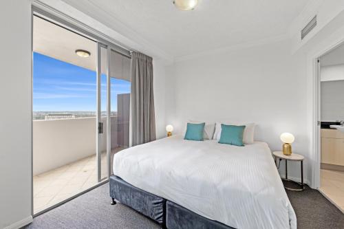 a bedroom with a large bed and a balcony at CLLIX Brisbane Central Apartments in Brisbane