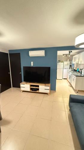 a large living room with a flat screen tv at Departamento cerca del Zocalo y aeropuerto in Mexico City