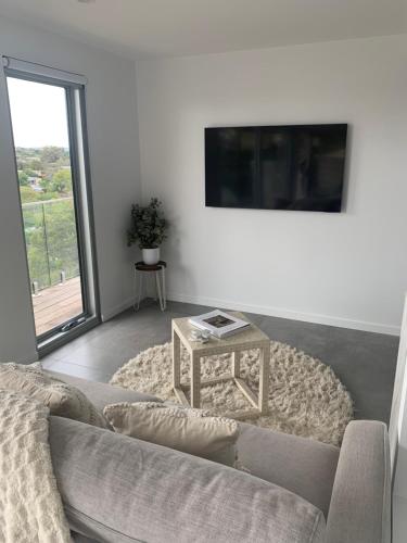 a living room with a couch and a table at Guest house - Ocean views in Rye