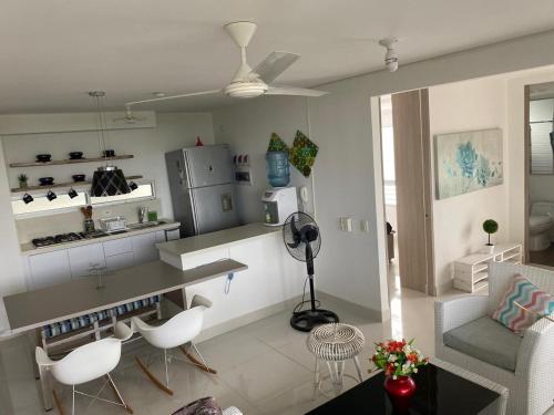 a kitchen and living room with a table and chairs at Apartamento Ricaurte 90 m2, 3 habitac, 6 personas, Peñazul La Morada LuisFeryClarita in Ricaurte