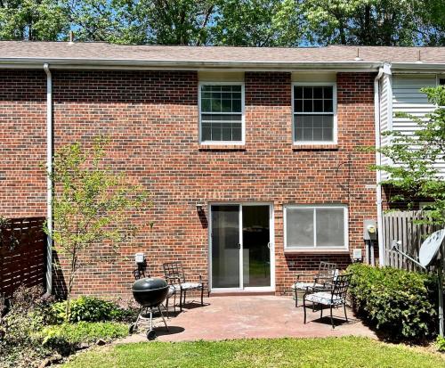 a brick house with a grill in front of it at Mins to Blessing Hospital, Miss River, Country Club in Quincy