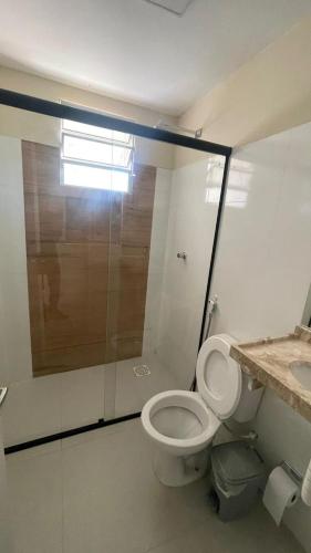 a bathroom with a toilet and a shower and a sink at Casa Beach park in Aquiraz