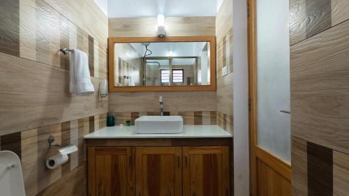 a bathroom with a sink and a mirror at Peyolis Place in Jāmb