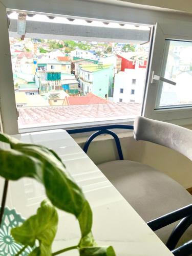 a table and a chair in a room with a window at Khách sạn An An Đà Lạt in Da Lat